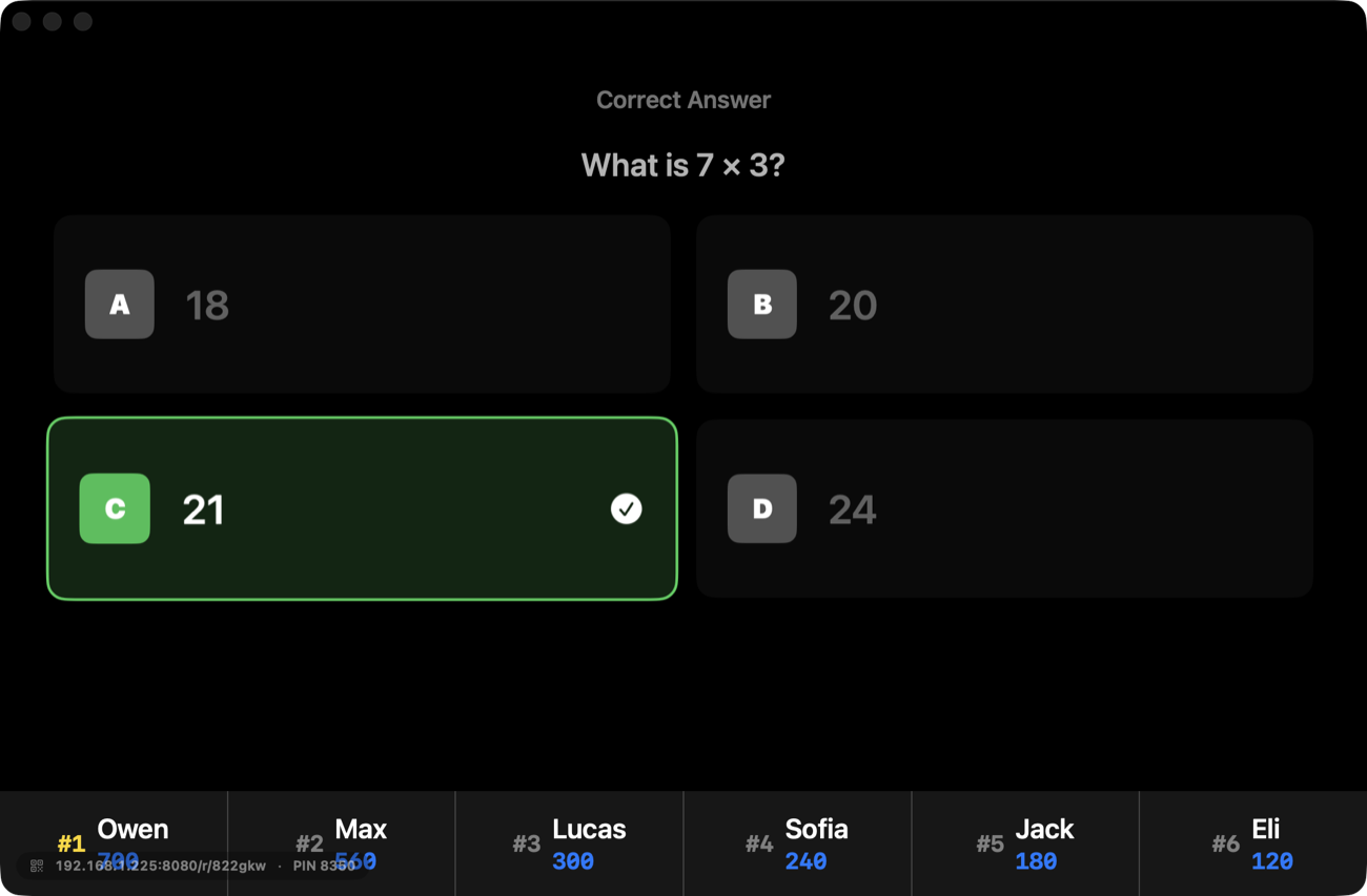A flashcard race on the projector: the correct answer to 7 × 3 highlighted in green, with the live leaderboard of student scores along the bottom.